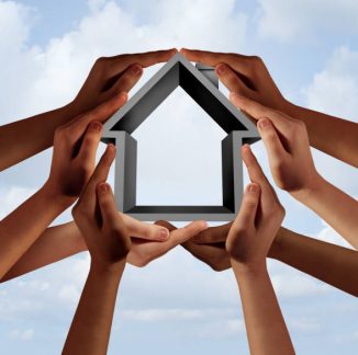 Social housing and affordable community property as a group of diverse hands holding a family house symbol with 3D illustration elements.
